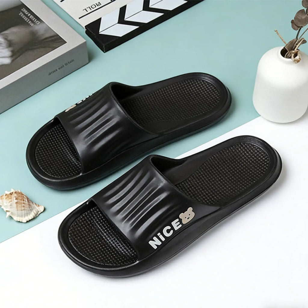 Black rubber unisex lightweight anti slip eva shower slides with textured footbed and nice branding in white lettering