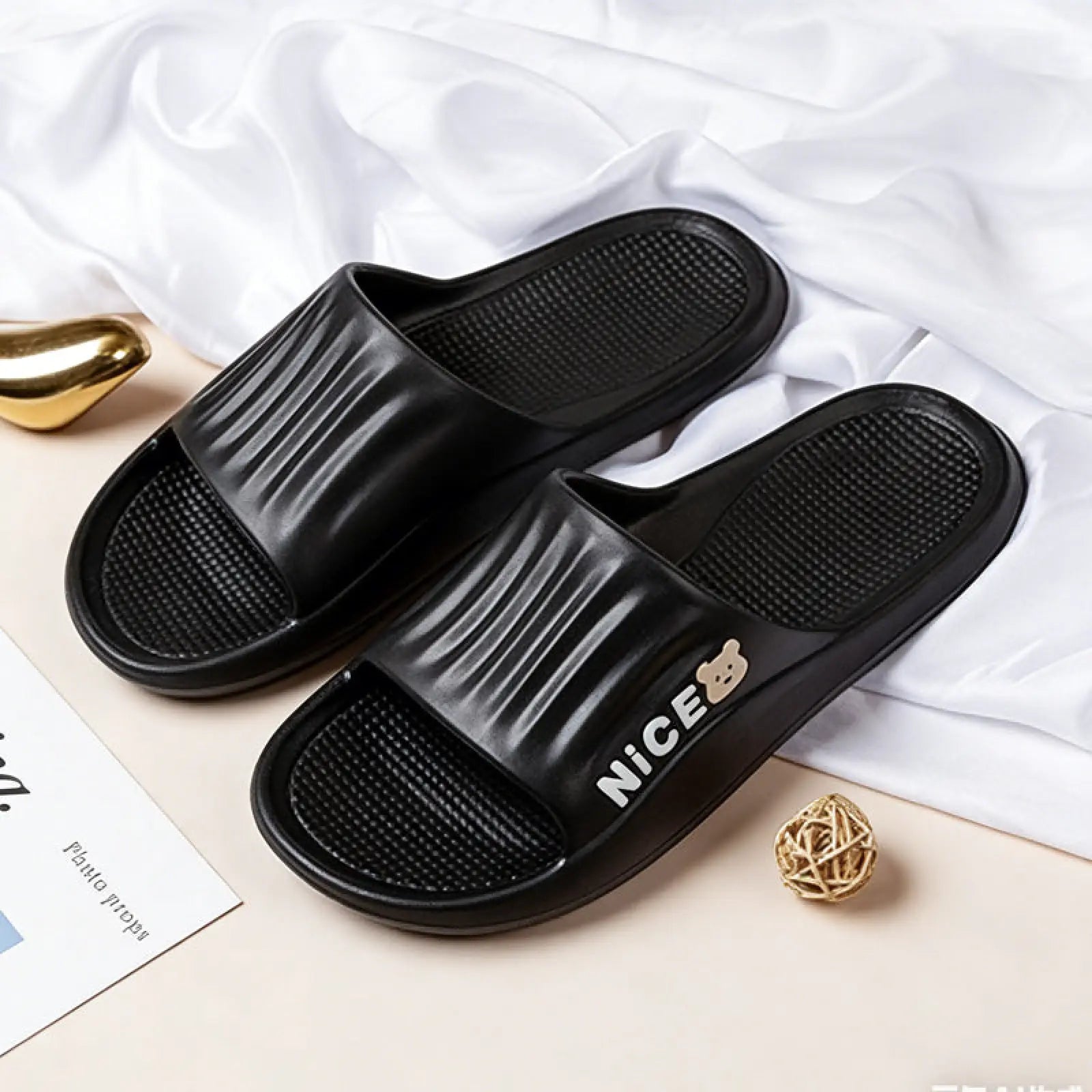 Black plastic unisex lightweight anti slip eva shower slides with ribbed texture and nice printed next to bear logo