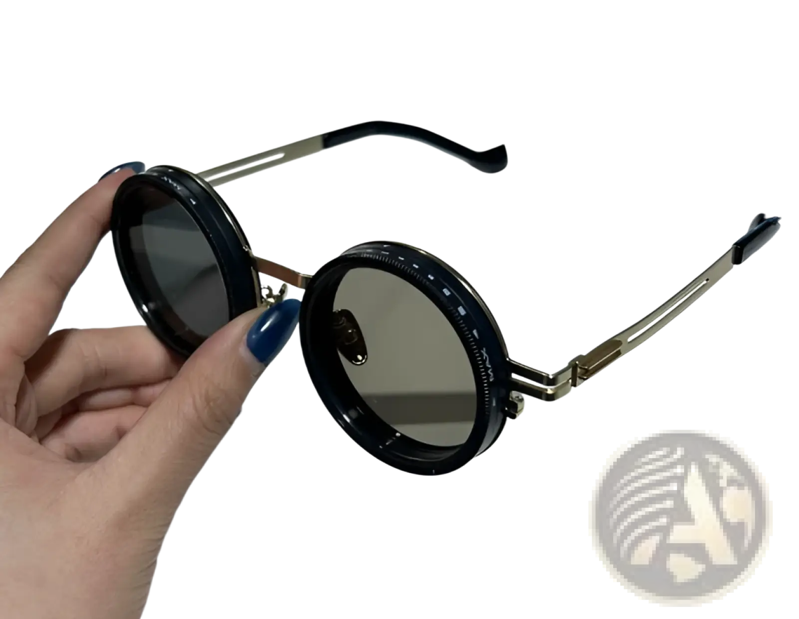Black unisex round uv resistant sunglasses with gold-tone metal frames and dark gray lenses held by a hand