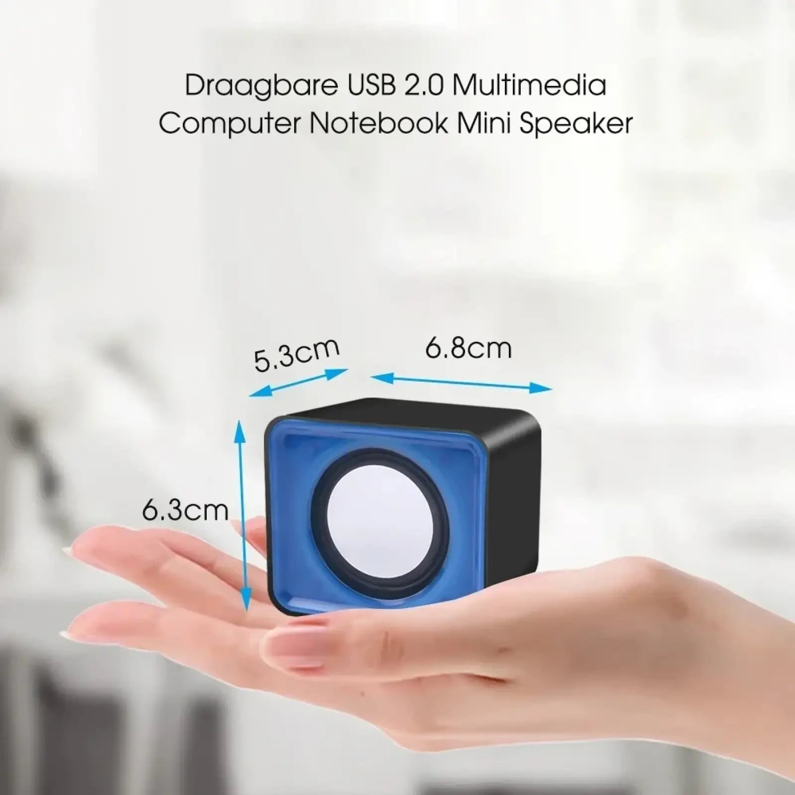 Blue and black USB 2.0 multimedia mini speaker with square design held in hand for scale for desktop computer use