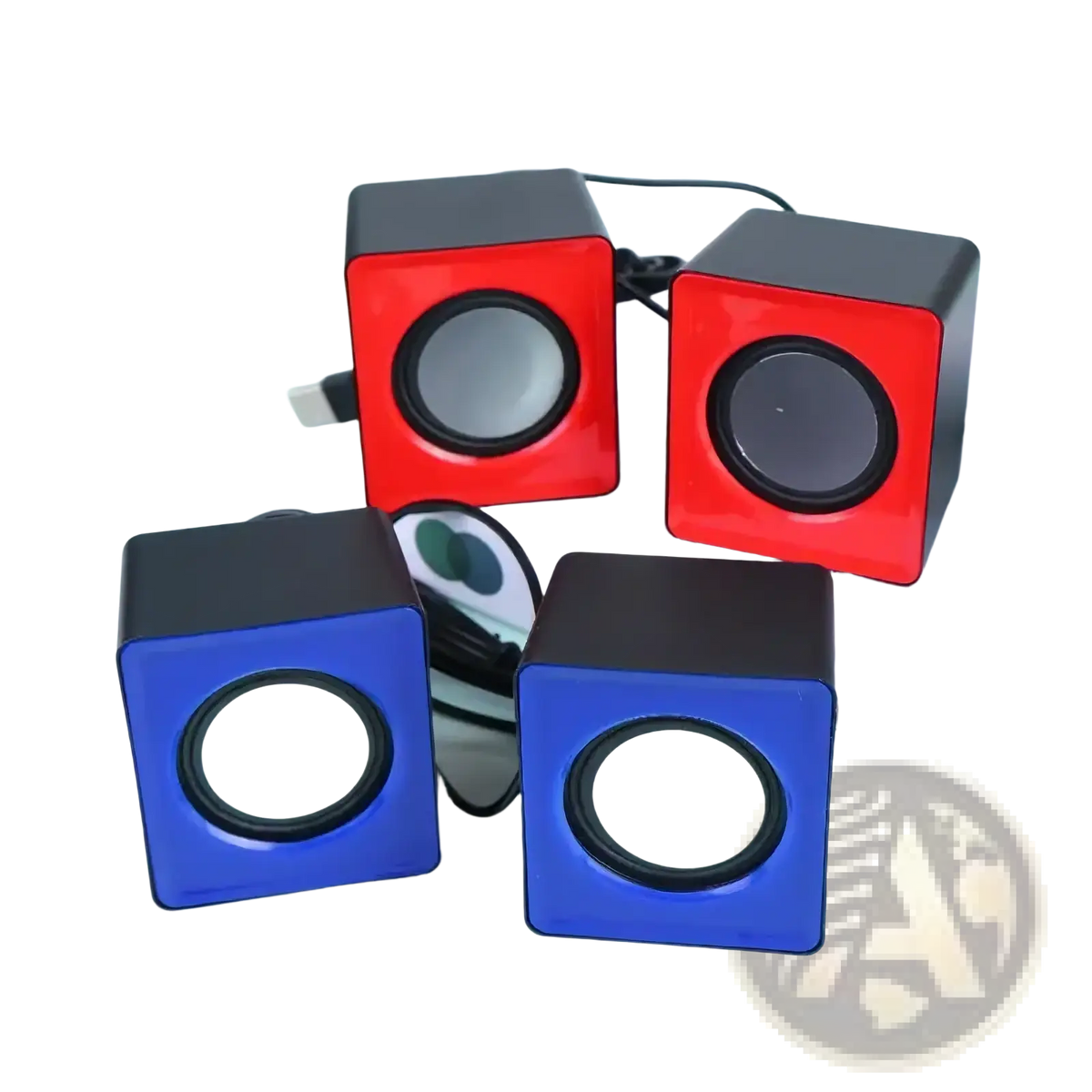 Set of four cube-shaped usb mini desktop speakers in red and blue with black accents featuring circular drivers for stereo audio