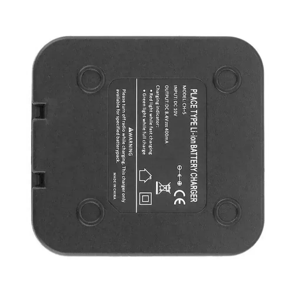 Black rectangular uv-5r charger base with rounded corners and four circular indentations for baofeng walkie talkie