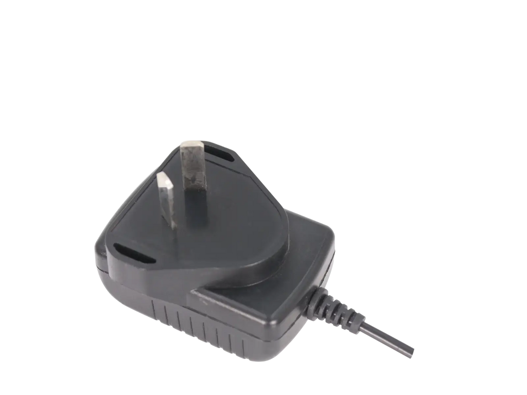 Black plastic uv-5r desktop charger with uk-style three-prong plug and coiled cord for baofeng walkie talkie