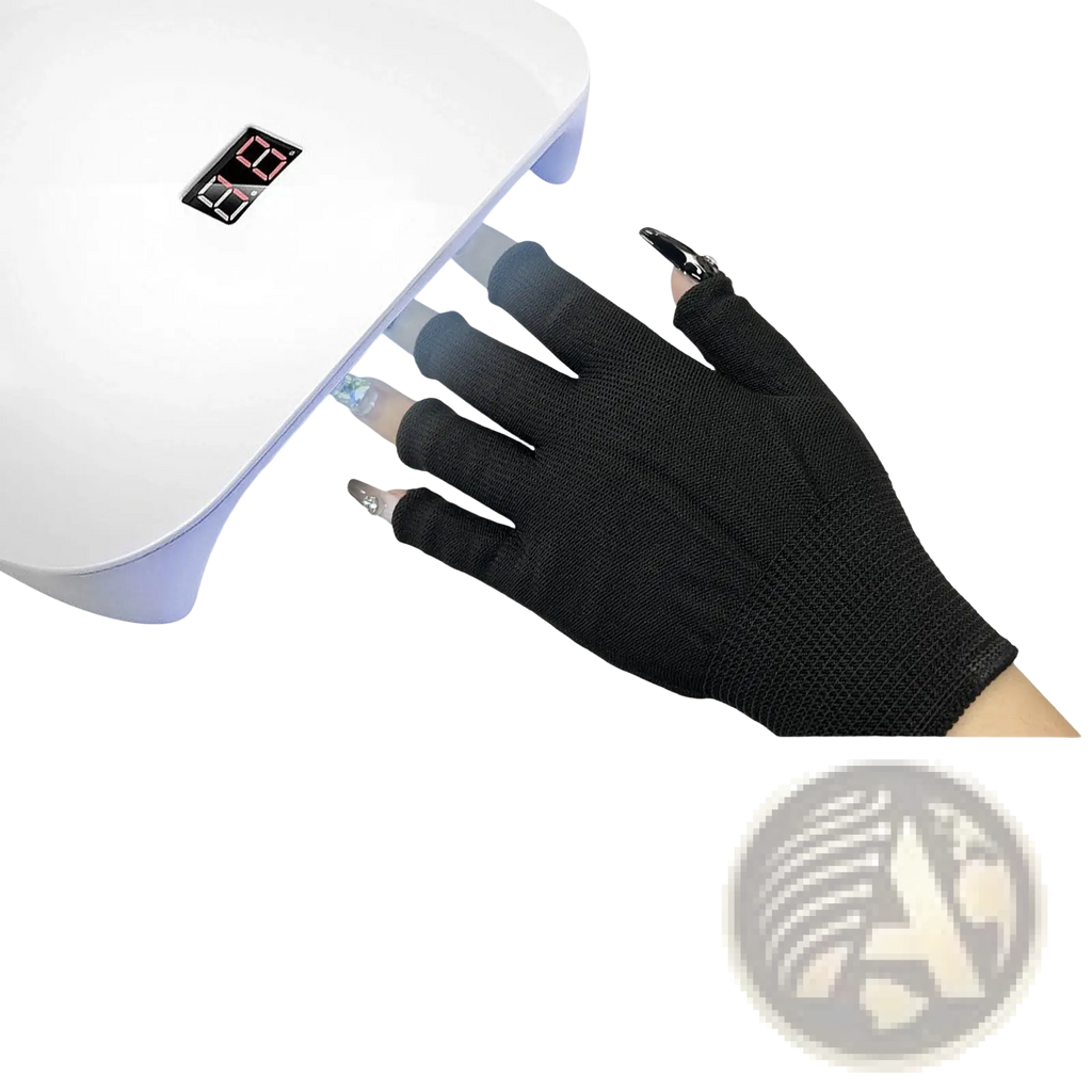 Black fingerless uv protection glove worn on hand under white uv lamp for nail care and drying purposes