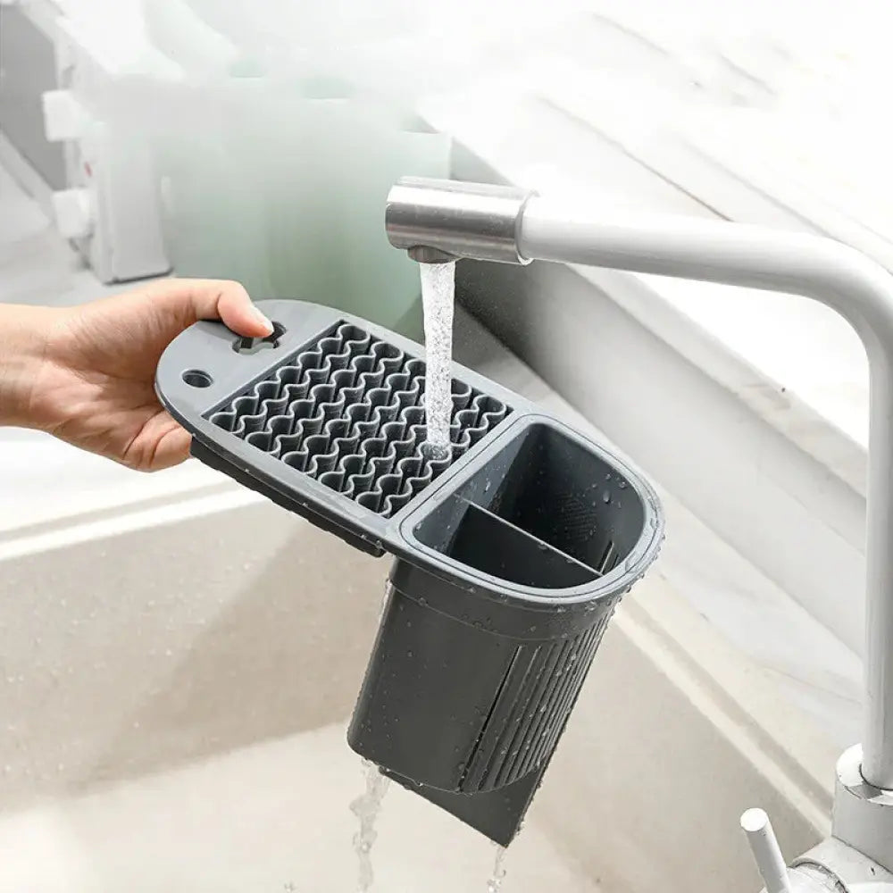 Black plastic kitchen utensil rack with textured grid and divided compartments for 360 rotating ceramic cutlery drainer