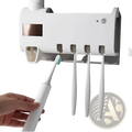 White electric toothbrush with teal bristles placed in uv sterilizer toothbrush holder and dispenser for hygiene