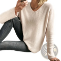 A soft off-white v-neck drop-shoulder knit sweater with ribbed cuffs and a relaxed long-sleeved fit
