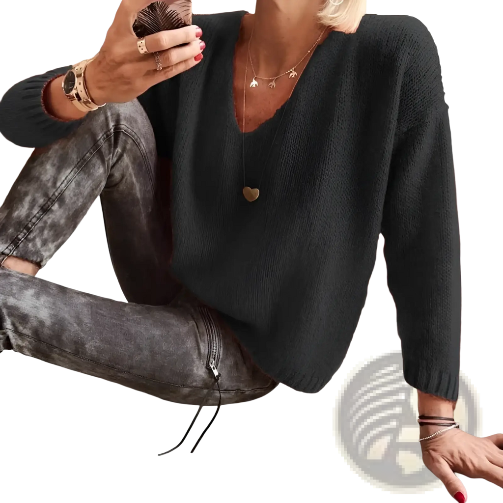 Black textured knit sweater with loose fit v-neckline and drop-shoulder design ideal for casual wear