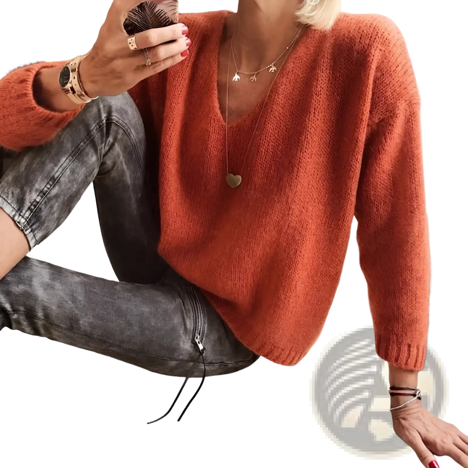 A cozy v-neck drop-shoulder knit sweater in rust-orange with a soft fuzzy texture and long sleeves