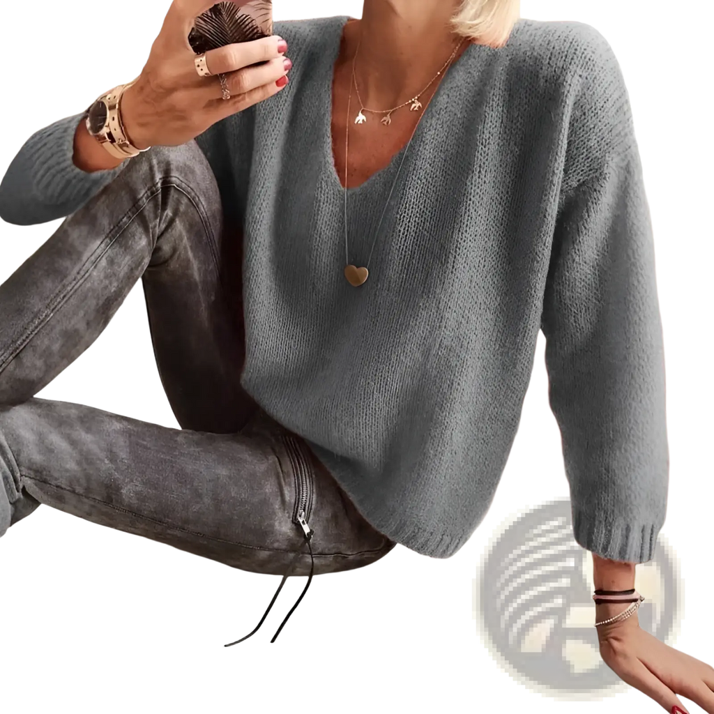Soft gray v-neck drop-shoulder knit sweater with long sleeves made of comfortable knit material