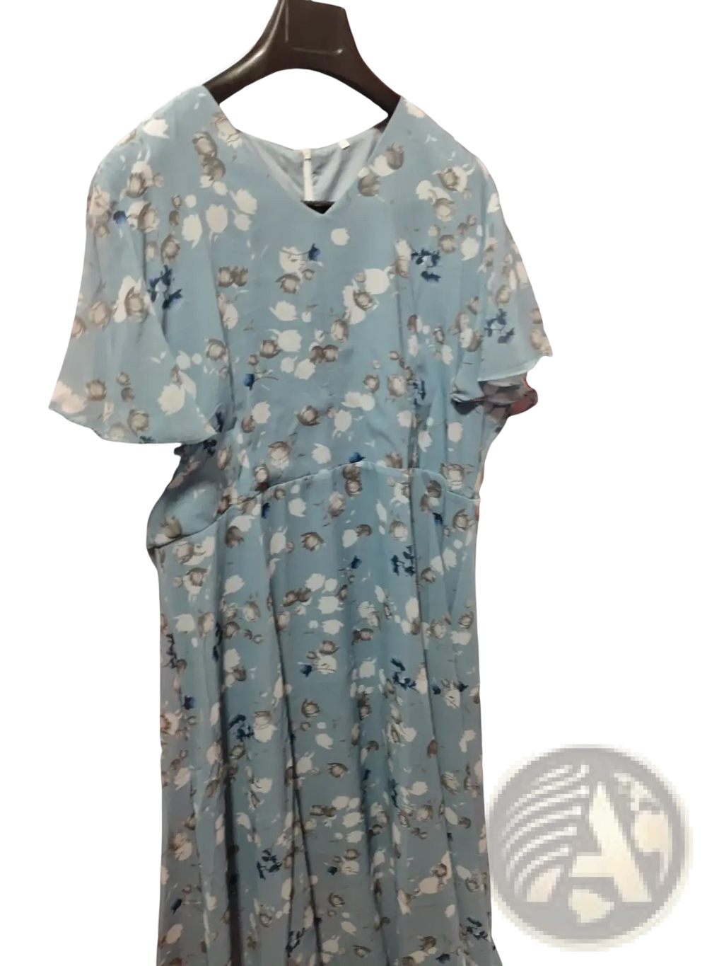 A light blue v-neck floral ruffle maxi summer dress with short flutter sleeves hanging on a dark wooden hanger