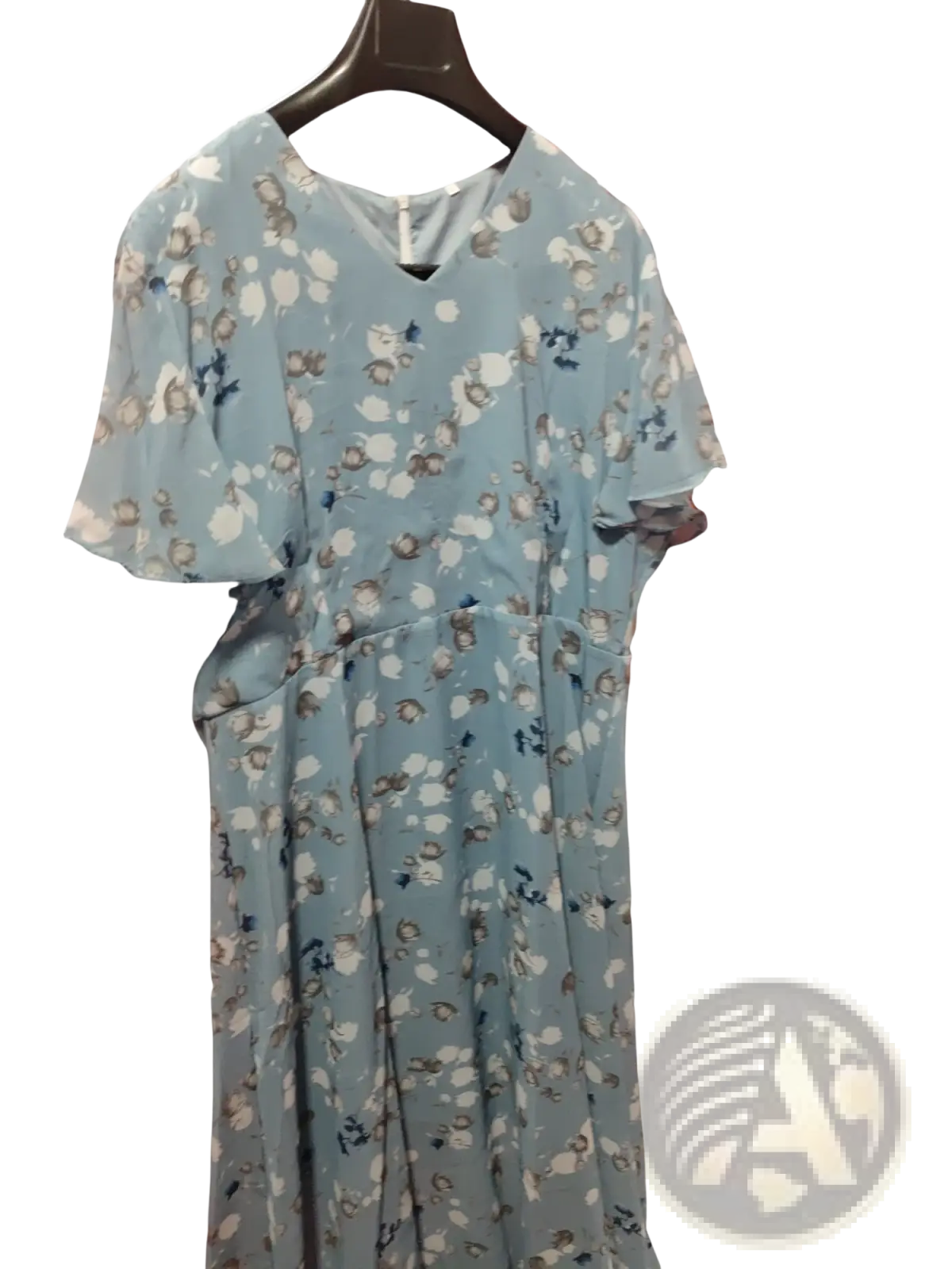 A light blue v-neck floral ruffle maxi summer dress with short flutter sleeves hanging on a dark wooden hanger