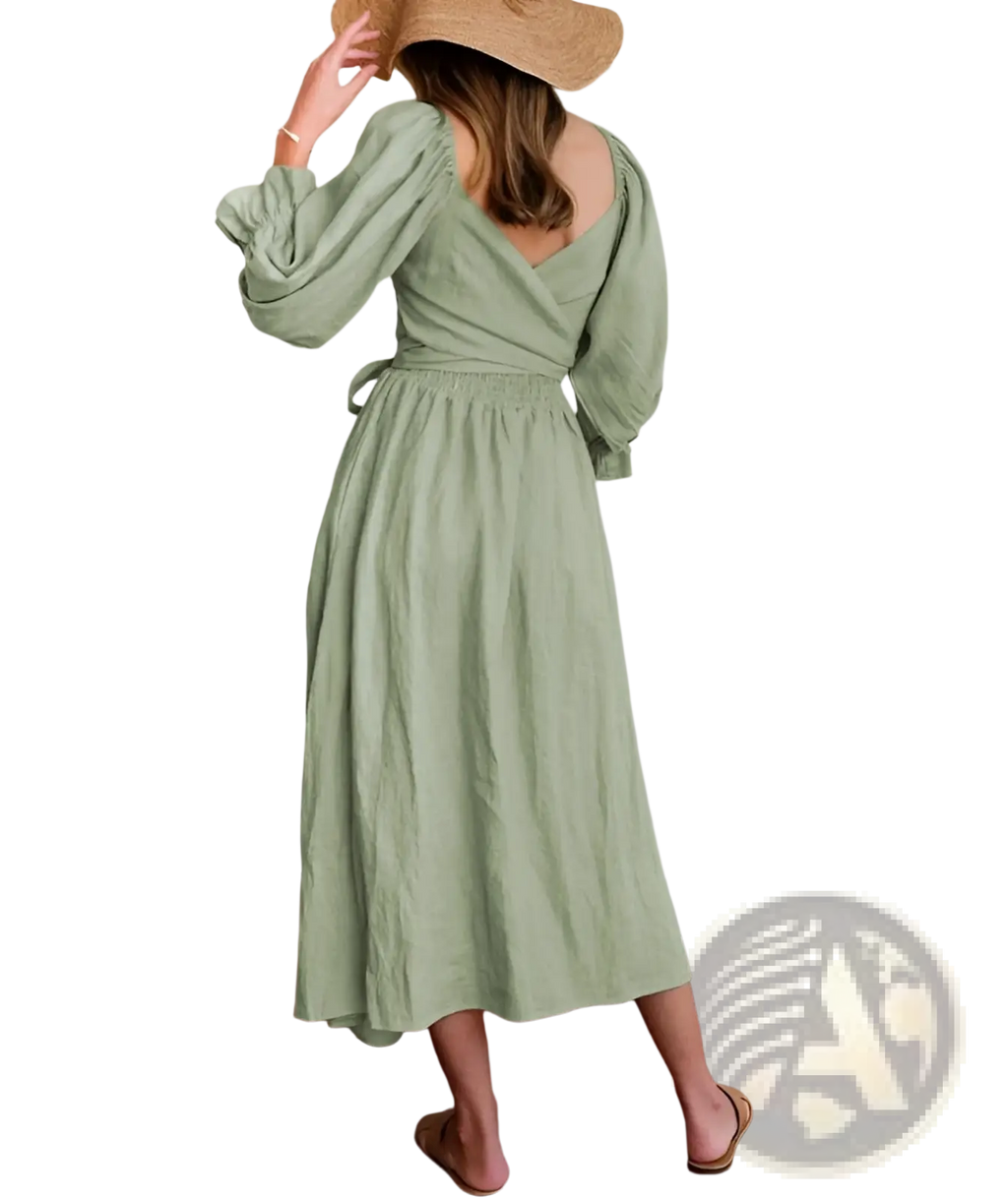 A soft sage green v-neck lantern sleeve reversible midi dress with long puffed sleeves and gathered waist