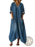 A medium-wash blue denim maxi dress with v-neckline rolled-up sleeves and large front pockets
