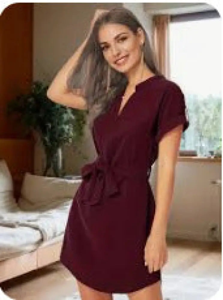 A maroon short sleeve belted wrap dress with v neckline and tied waistband for elegant casual wear