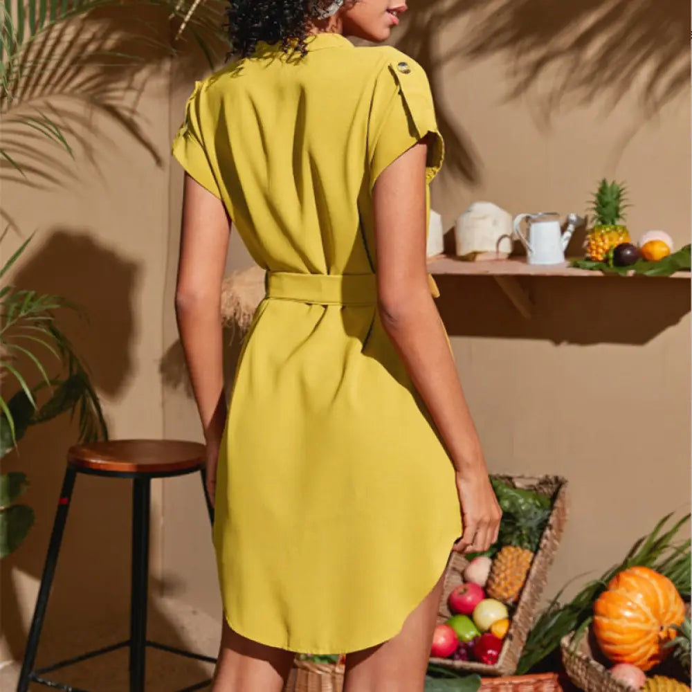 A vibrant yellow short-sleeved belted wrap dress with subtle shoulder details and a v neck design