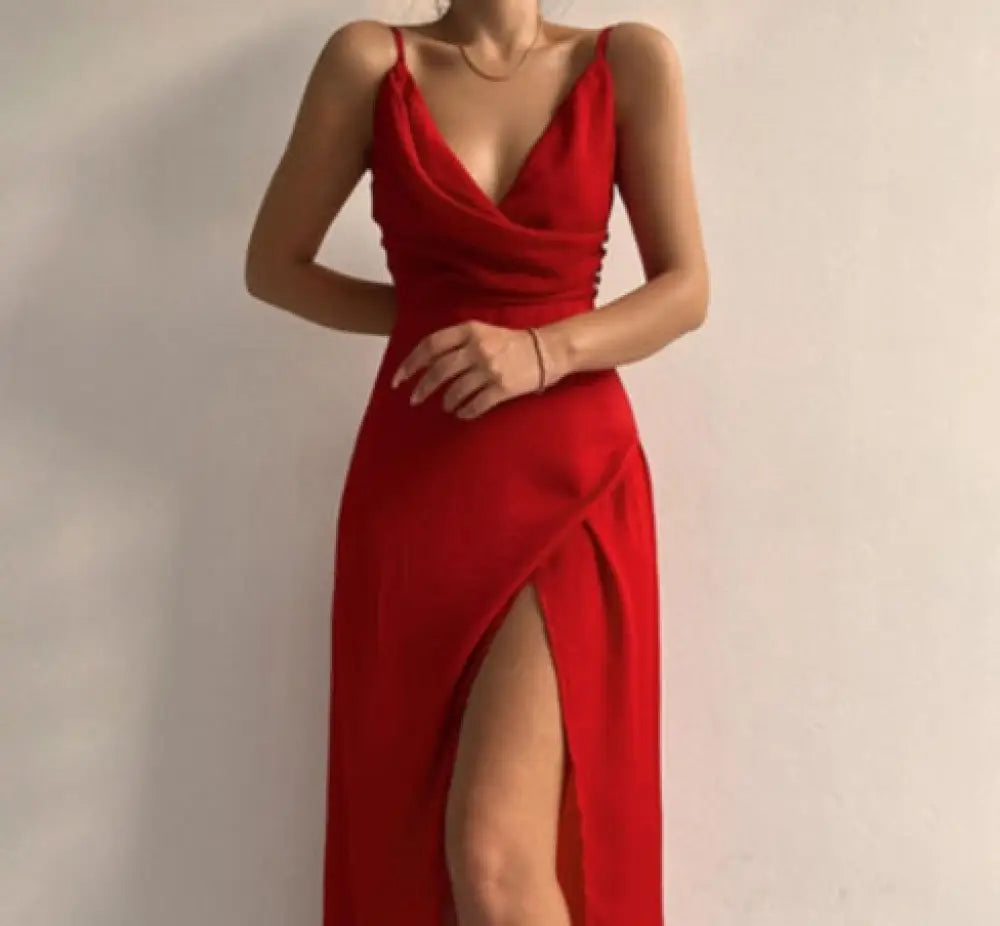 A vibrant red satin summer maxi dress with a deep v neck and high slit perfect for evening wear
