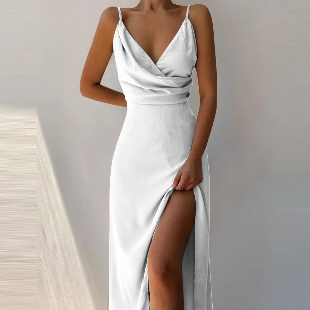 A sleek white satin v neck summer maxi slip dress with thin spaghetti straps and a high slit