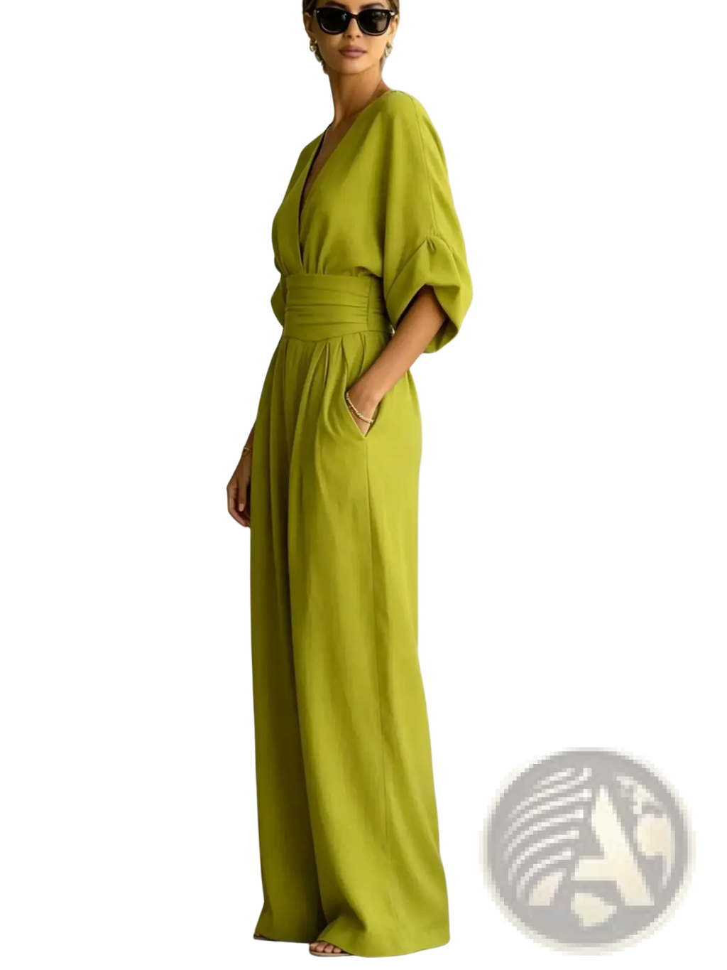 A woman wearing a vibrant lime green v-neck wide-leg jumpsuit with flowing fabric wide sleeves and a cinched waist