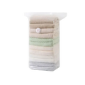 Transparent vacuum storage bags with white valve containing neatly folded neutral tone garments for clothes and quilts storage