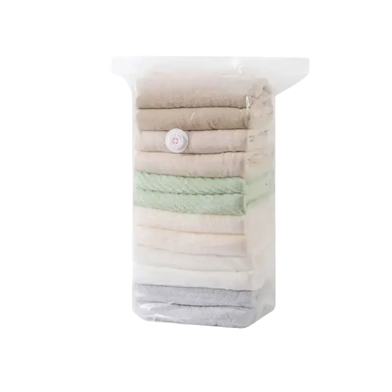 Transparent vacuum storage bags with white valve containing neatly folded neutral tone garments for clothes and quilts storage