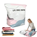 A pink gray and white inflatable vacuum storage bag with life space creator label made of pa+pe material
