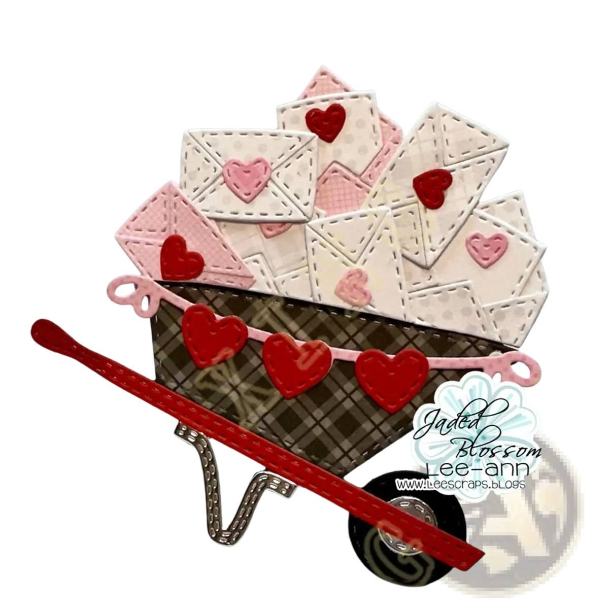 A charming miniature metal wheelbarrow with brown plaid body and red pink hearts from Valentine gnome dies and stamps