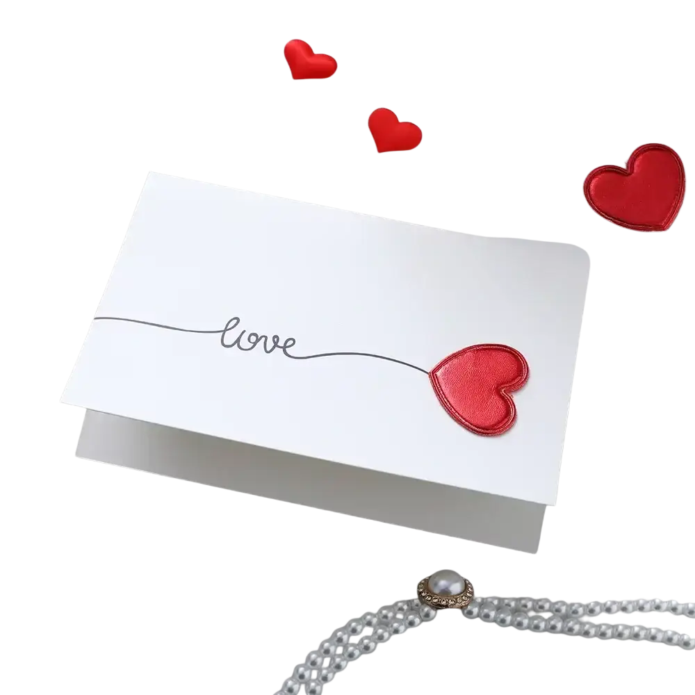 White valentine heart greeting card with love in black cursive and shiny red heart appliqué for wedding invitations