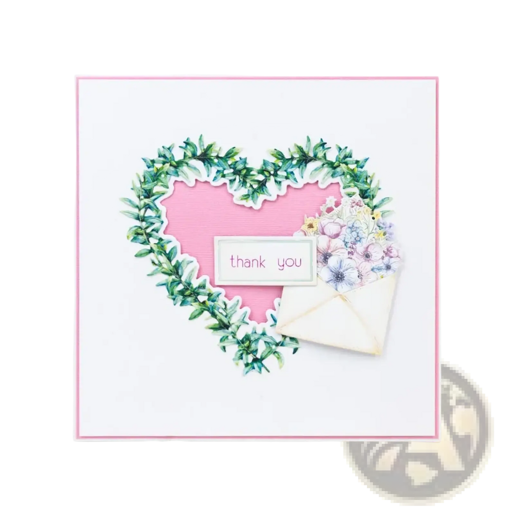 Valentine metal cutting die featuring a delicate pink thank you card with a green leafy heart wreath and pastel flowers