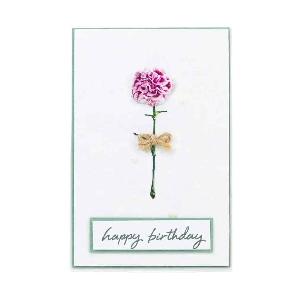 Valentine metal cutting die featuring a delicate pink and white fabric carnation tied with rustic twine on a birthday card