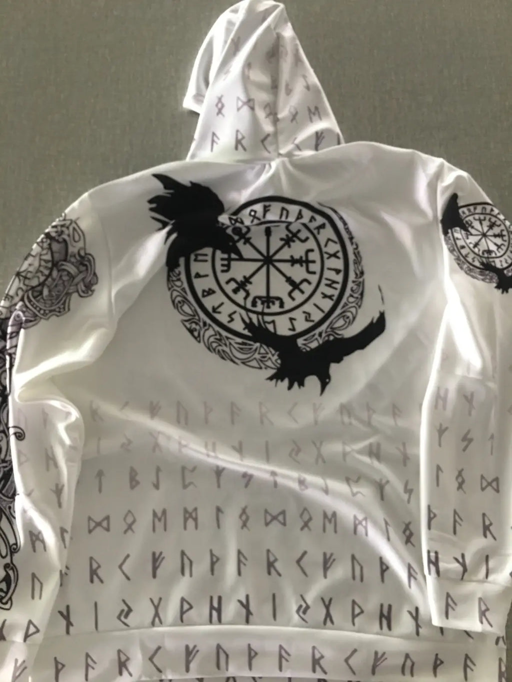 White hooded zip up sweatshirt with black Norse runes and Viking compass design featuring two ravens
