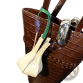 Brown crocodile-embossed patent leather bucket bag with green strap and silver hardware for designer purse ornaments
