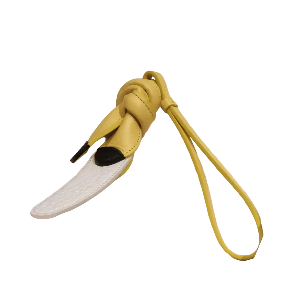 Yellow leather banana-shaped keychain with black-tipped ends and white textured strap for vegetable leather handbag charms