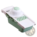 Vegetable slicer mandoline grater with adjustable blades featuring a sleek mint green base and white top for precise cutting