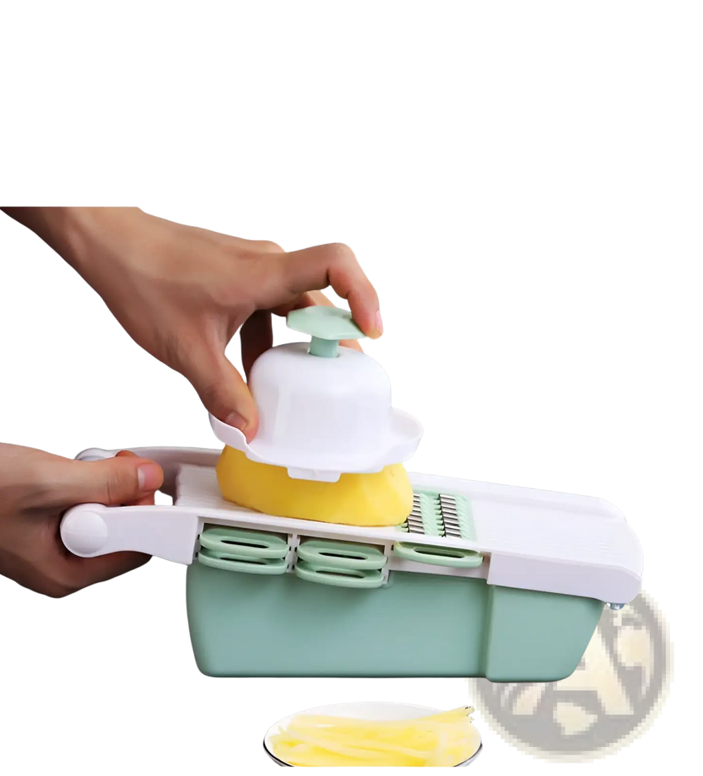 Vegetable slicer mandoline grater with blades in white and mint green slicing a yellow potato into thin strips