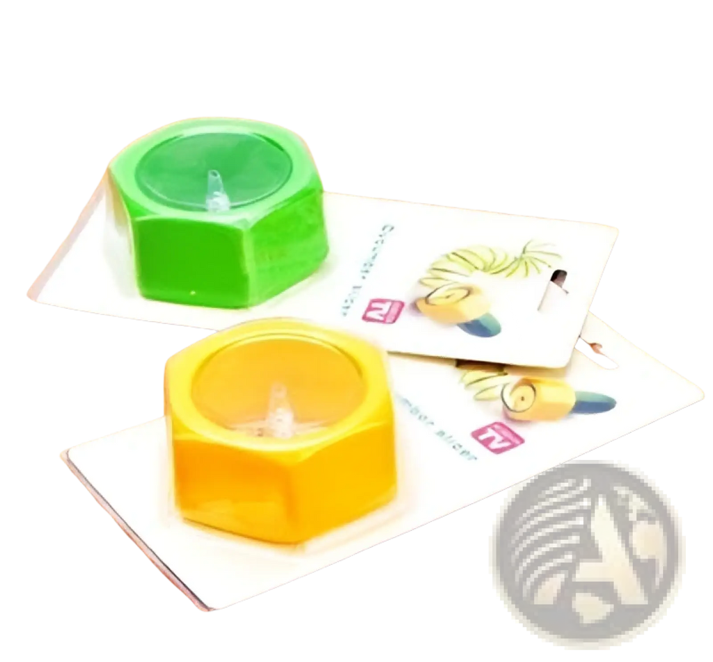 Green and yellow hexagonal candle holders with clear glass centers for decor next to a manual vegetable spiralizer cutter