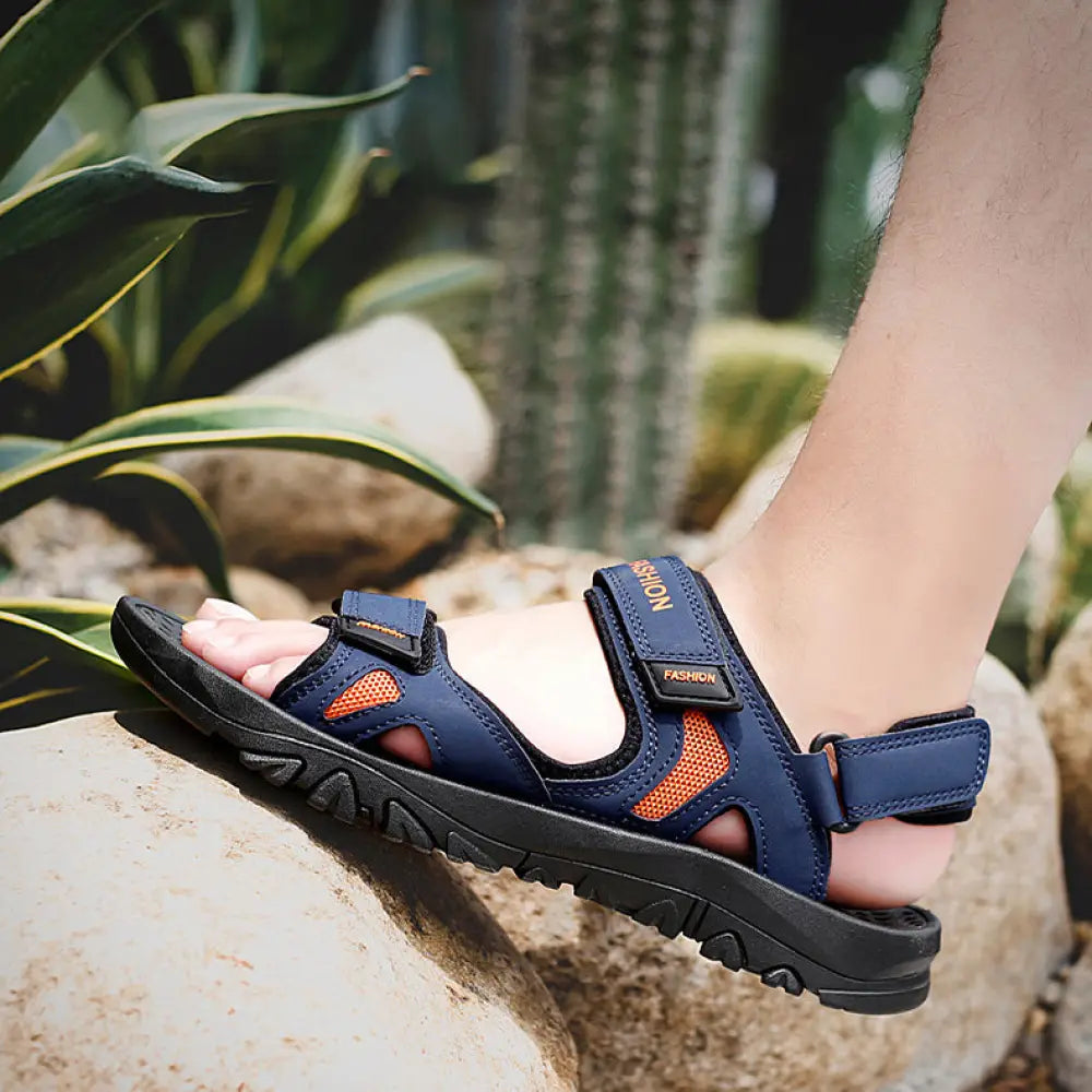 Men’s breathable athletic velcro beach sandals in blue and orange with adjustable straps and textured rubber sole