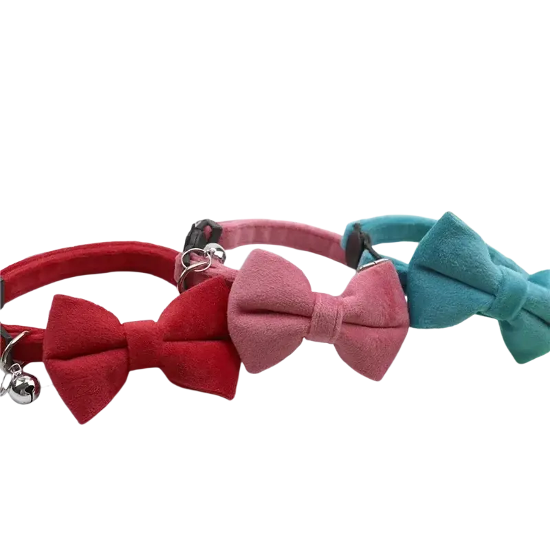Three suede velvet bow cat collars in red pink and teal with silver bells for stylish pet accessory use