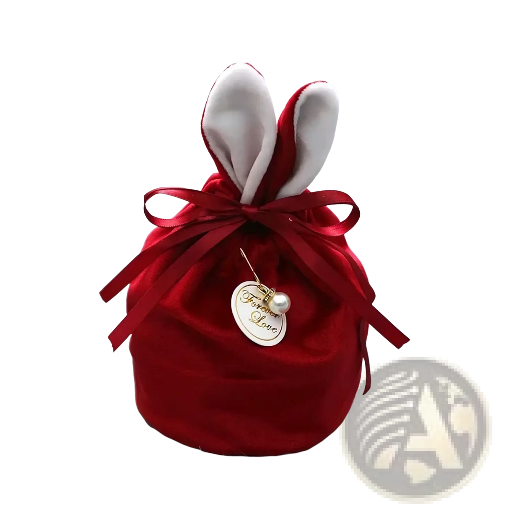 Red velvet bunny-shaped gift pouch with white inner ears tied with matching ribbon and forever love pearl charm