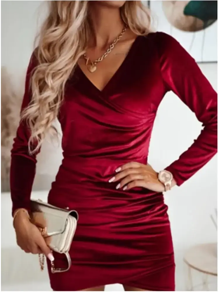 A rich burgundy velvet long sleeve wrap mini dress with a flattering v neckline and ruched detailing