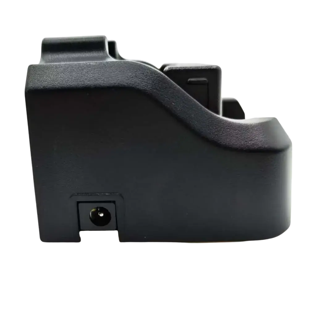 Black plastic textured camera battery grip with integrated charging port for vhf marine radio rs-38m charger back side