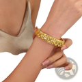 Vintage 18k gold plated filigree bangle bracelet featuring a detailed four leaf clover pattern in golden color