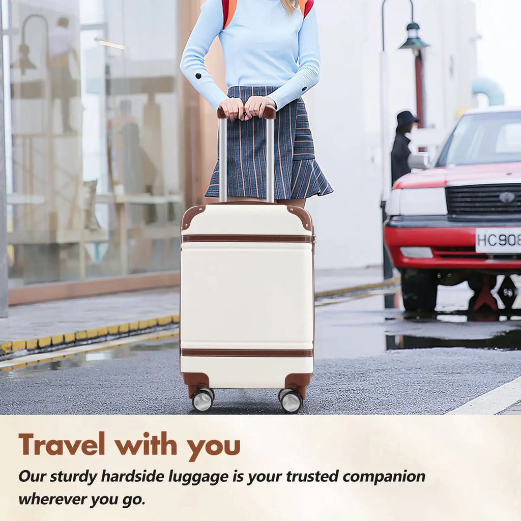 Cream-colored vintage 24 inch hardshell luggage with brown leather accents four wheels and tsa lock in white