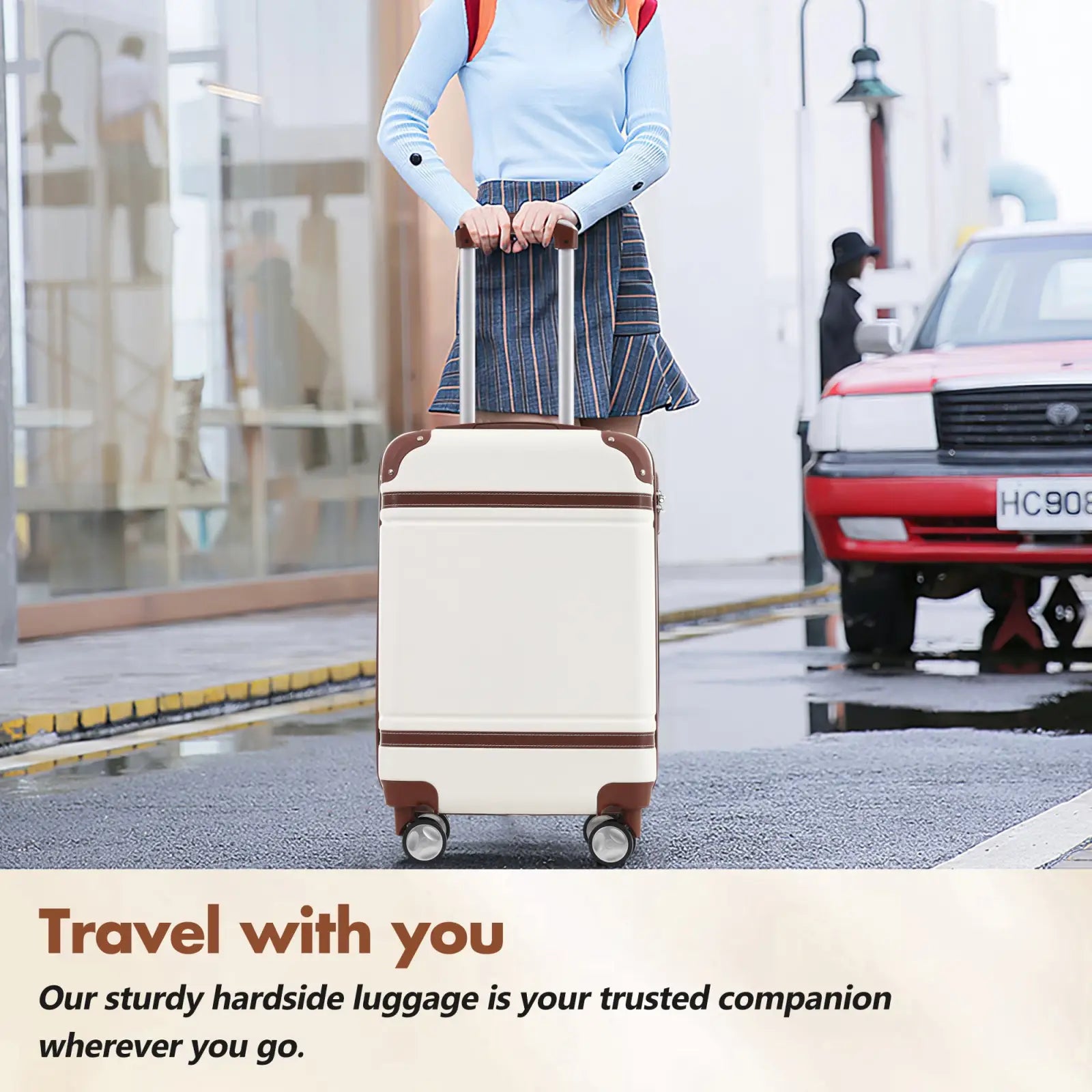 Cream-colored vintage 24 inch hardshell luggage with brown leather accents four wheels and tsa lock in white