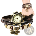 Vintage bohemian watch with an antique brass round face and dark brown braided leather straps with butterfly charms