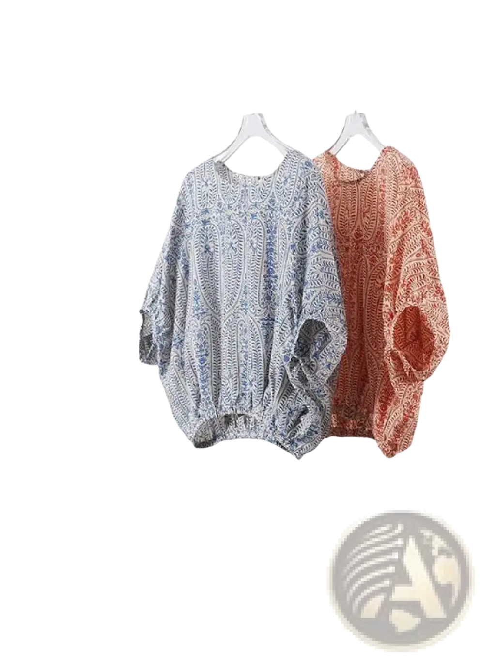 Two vintage bow batwing chiffon blouses with paisley patterns in muted blue white and terracotta orange hang side by side