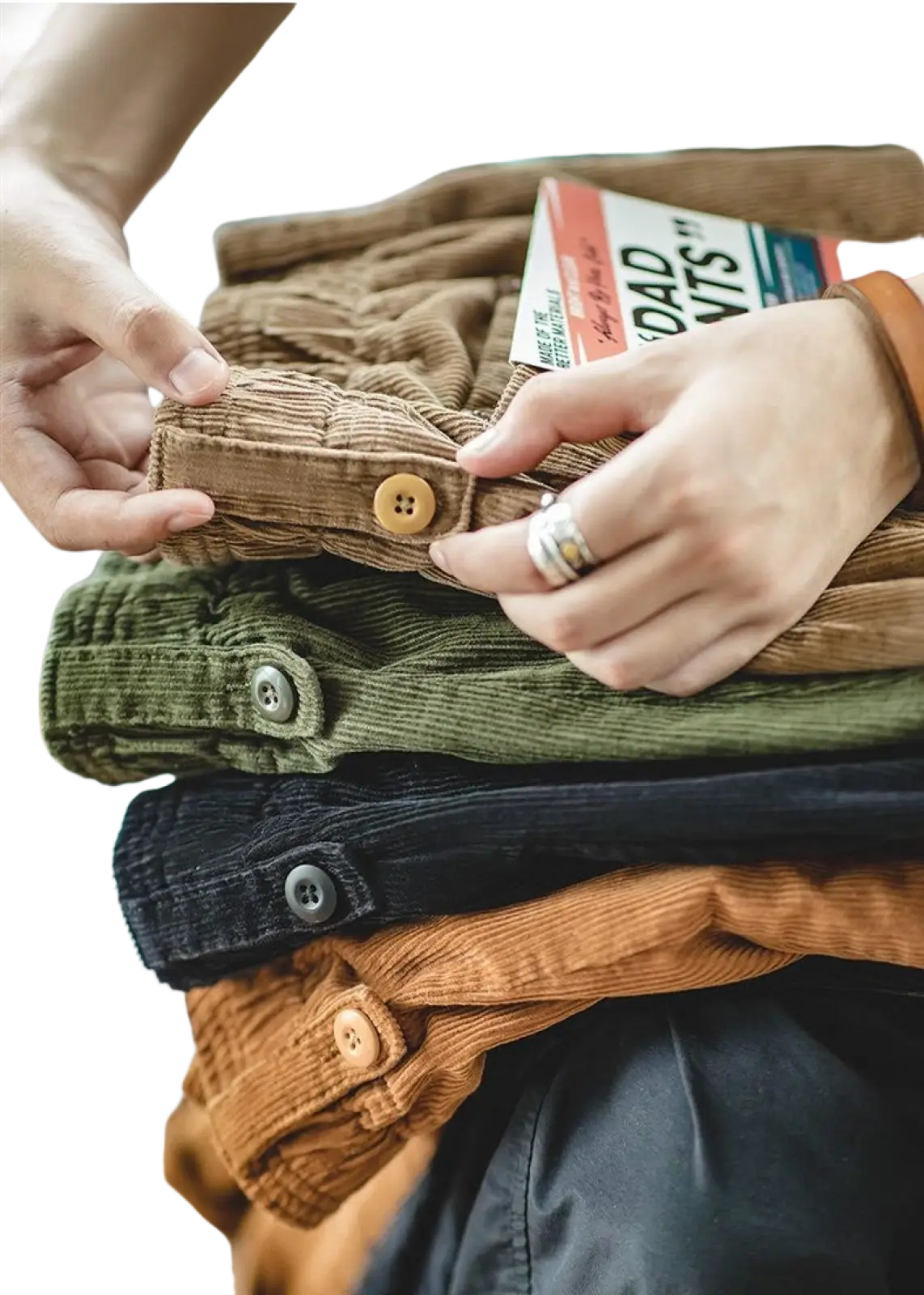 Stacked vintage brown corduroy cargo pants in earthy tones featuring button closures and textured weave