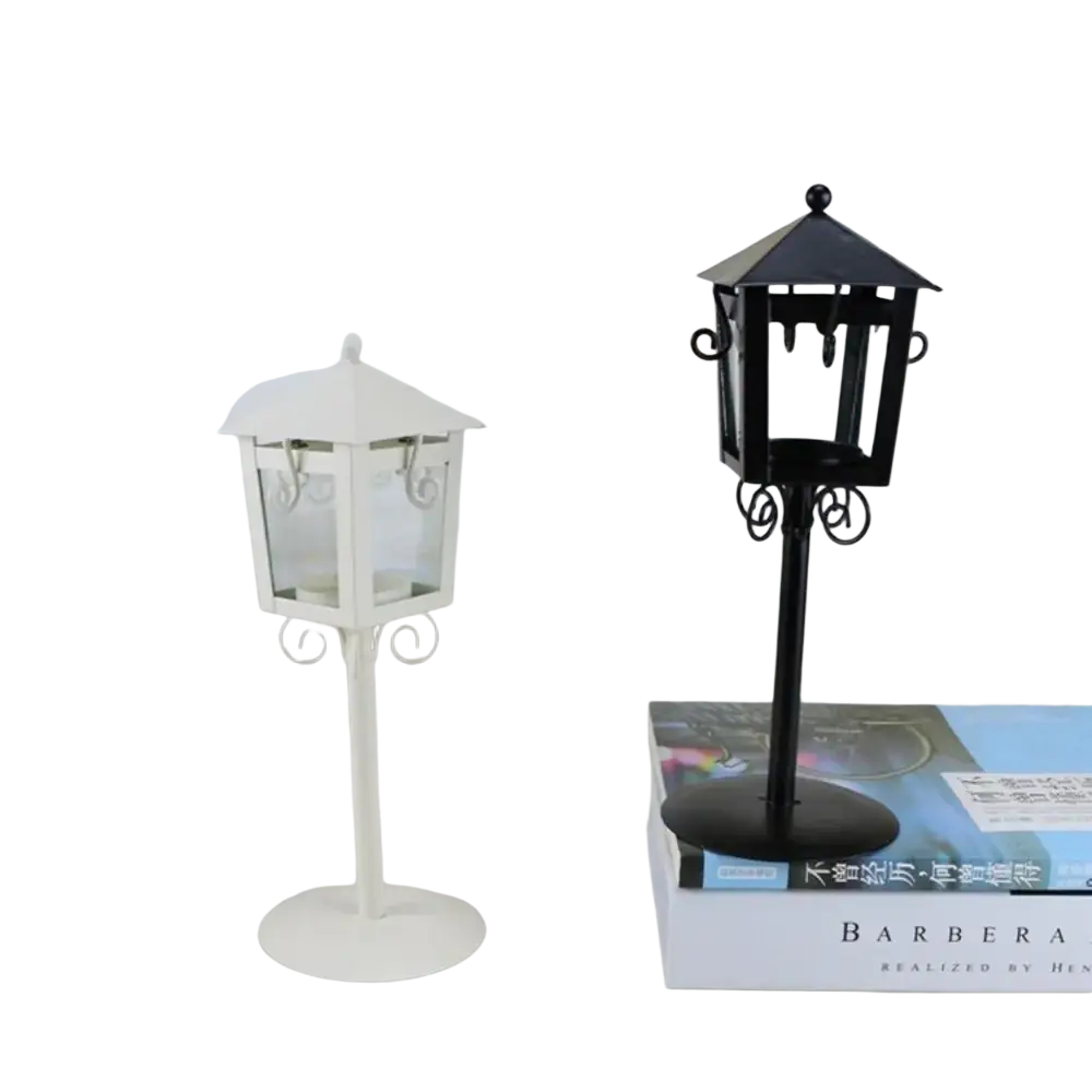 Black metal vintage candle holder lantern with ornate scrollwork and clear glass panels for elegant candle display
