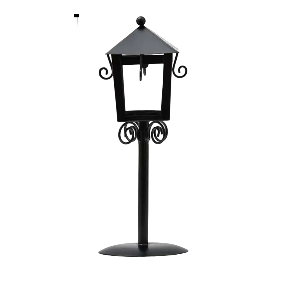 Black wrought iron vintage candle holder lantern with ornate scrollwork and pointed roof for garden decor