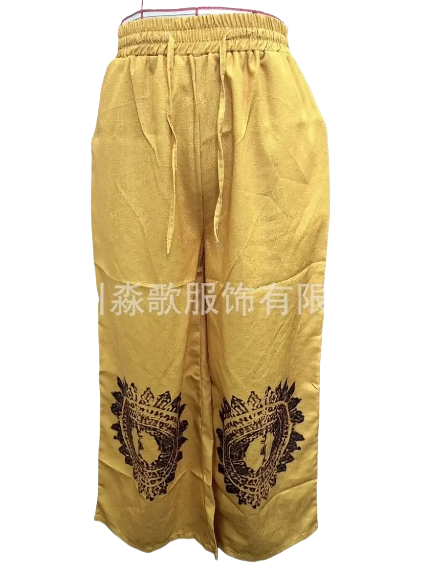 Vintage casual wide yellow wide leg pants with black dragon head embroidery on lower legs in casual pants style